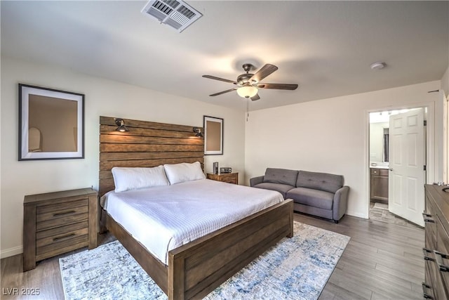 bedroom featuring visible vents, a ceiling fan, baseboards, and wood finished floors