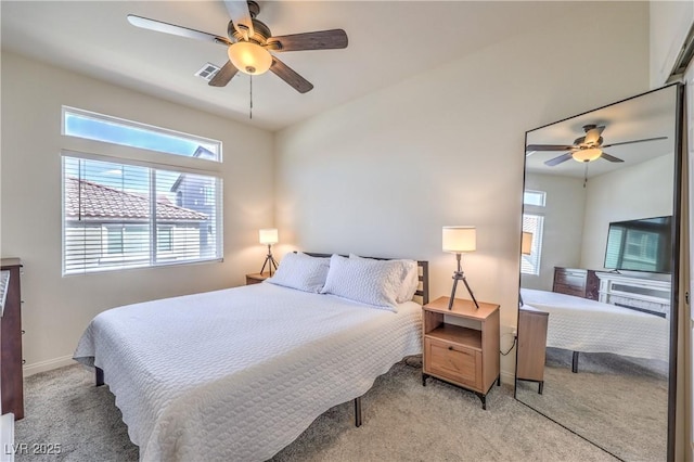 bedroom with visible vents, baseboards, ceiling fan, and light carpet