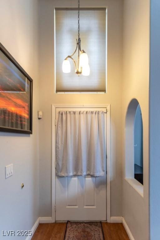 3008 Blue Fin Cir, Las Vegas, NV 89128 - foyer featuring baseboards, wood finished floors, and a chandelier