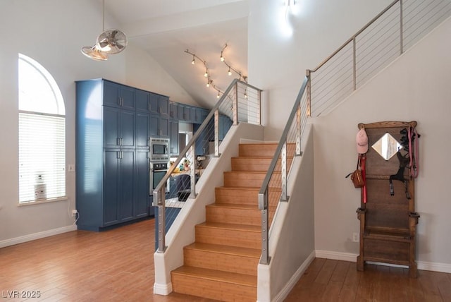 3008 Blue Fin Cir, Las Vegas, NV 89128 - stairway with wood finished floors, baseboards, and high vaulted ceiling