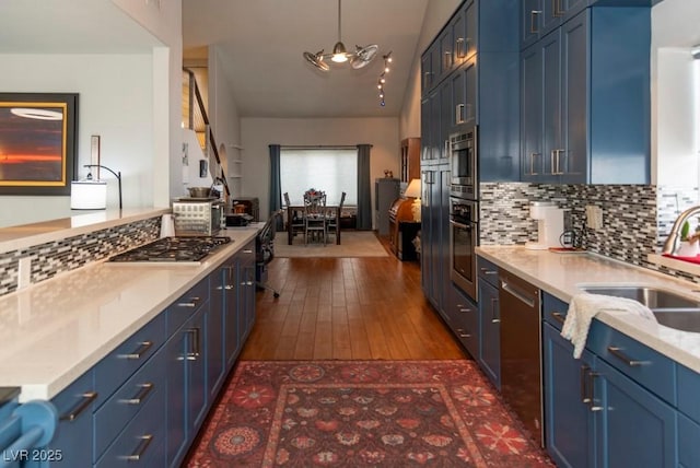 3008 Blue Fin Cir, Las Vegas, NV 89128 - kitchen featuring blue cabinets, a sink, appliances with stainless steel finishes, tasteful backsplash, and dark wood-style floors