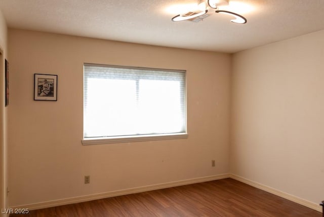 3008 Blue Fin Cir, Las Vegas, NV 89128 - spare room featuring wood finished floors, baseboards, and a textured ceiling