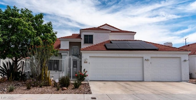 3008 Blue Fin Cir, Las Vegas, NV 89128 - mediterranean / spanish house featuring driveway, an attached garage, solar panels, a tiled roof, and stucco siding