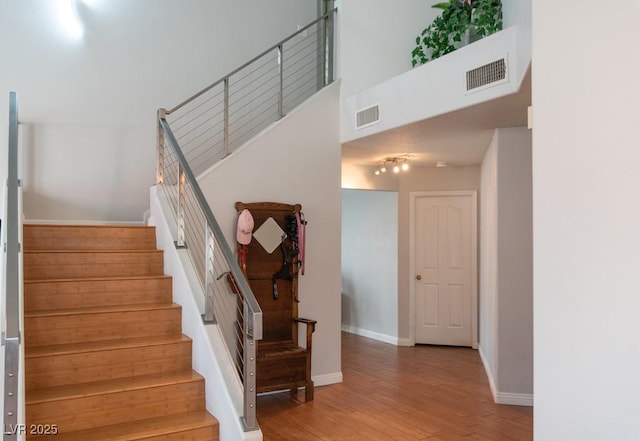 3008 Blue Fin Cir, Las Vegas, NV 89128 - stairs featuring wood finished floors, baseboards, and a high ceiling