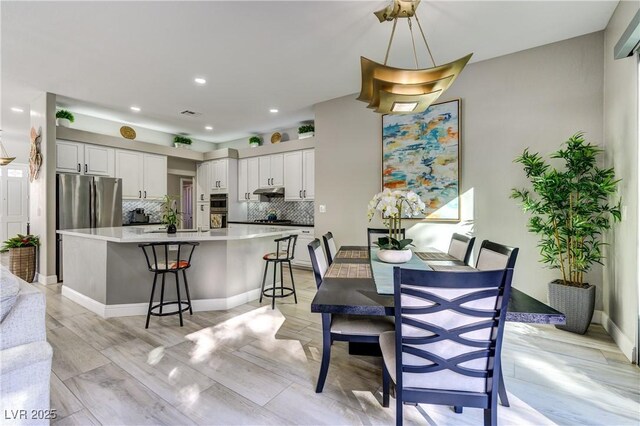 dining room featuring recessed lighting, light wood finished floors, and visible vents