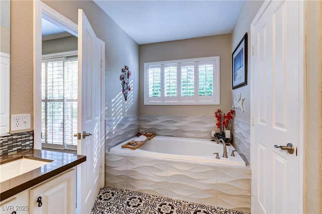 full bathroom featuring tile patterned floors, a wealth of natural light, a bath, and vanity