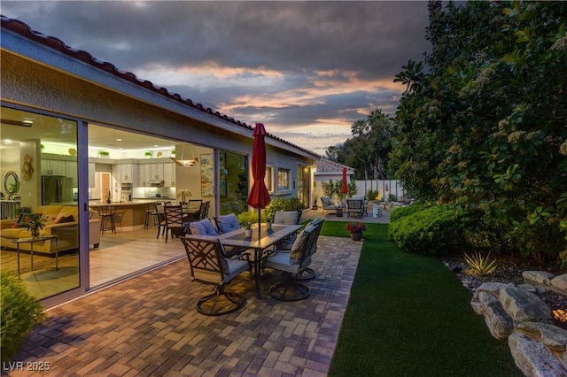 view of patio featuring fence, outdoor dry bar, and outdoor dining space