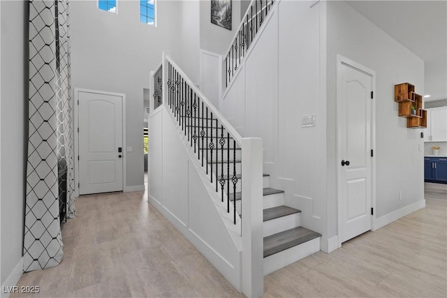 3268 Grayson Lake Ct, Las Vegas, NV 89129 - stairs featuring baseboards, a high ceiling, and wood finished floors