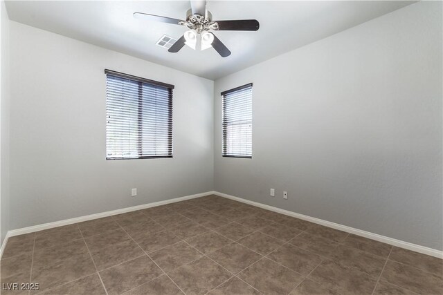 9807 Sage Canyon St, Las Vegas, NV 89178 - spare room featuring baseboards, ceiling fan, dark tile patterned flooring, and visible vents