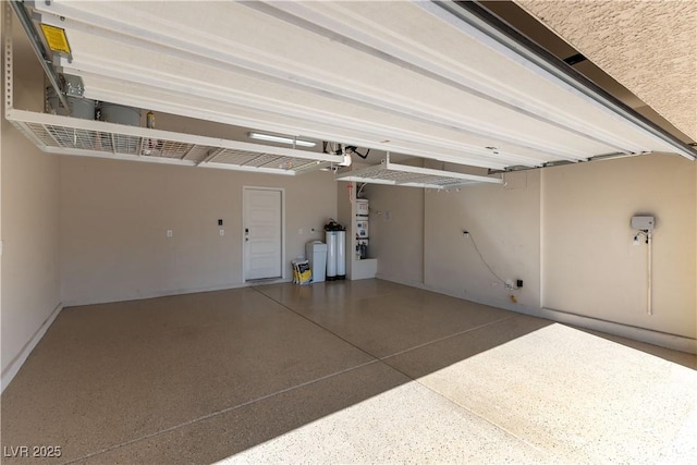 garage featuring heating unit and baseboards
