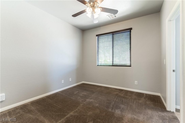 carpeted spare room featuring baseboards, a ceiling fan, and visible vents