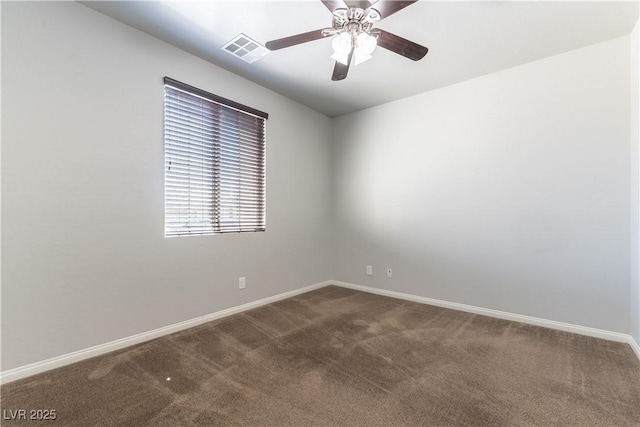 unfurnished room featuring baseboards, a ceiling fan, dark carpet, and visible vents