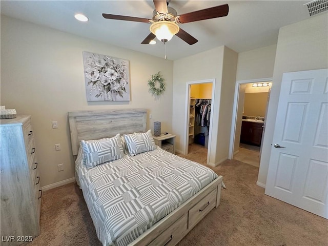 bedroom featuring light carpet, baseboards, a spacious closet, visible vents, and a closet
