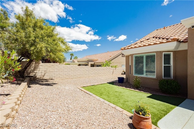 view of yard with a fenced backyard