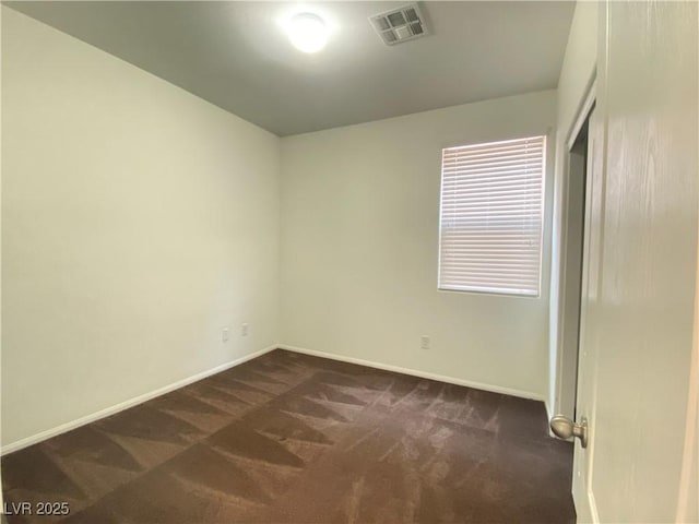 5513 Silent Springs Dr, Las Vegas, NV 89122 - unfurnished room with baseboards, visible vents, and dark colored carpet