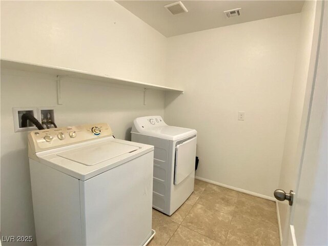 5513 Silent Springs Dr, Las Vegas, NV 89122 - washroom featuring laundry area, visible vents, washing machine and clothes dryer, baseboards, and light tile patterned flooring