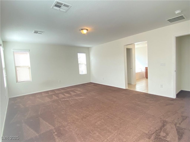 5513 Silent Springs Dr, Las Vegas, NV 89122 - spare room featuring light colored carpet, baseboards, and visible vents