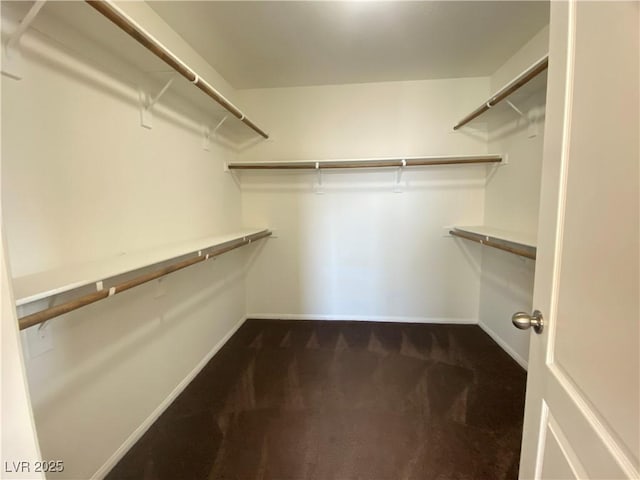 5513 Silent Springs Dr, Las Vegas, NV 89122 - walk in closet featuring dark carpet