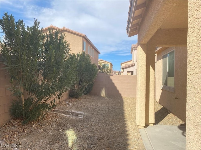5513 Silent Springs Dr, Las Vegas, NV 89122 - view of side of property with stucco siding and fence