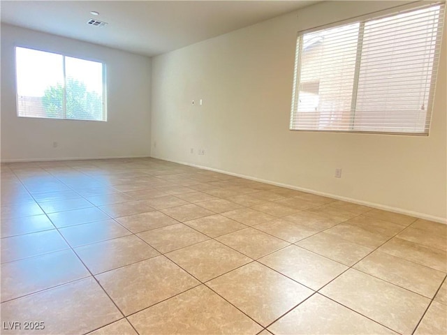 5513 Silent Springs Dr, Las Vegas, NV 89122 - empty room with light tile patterned flooring, baseboards, and visible vents