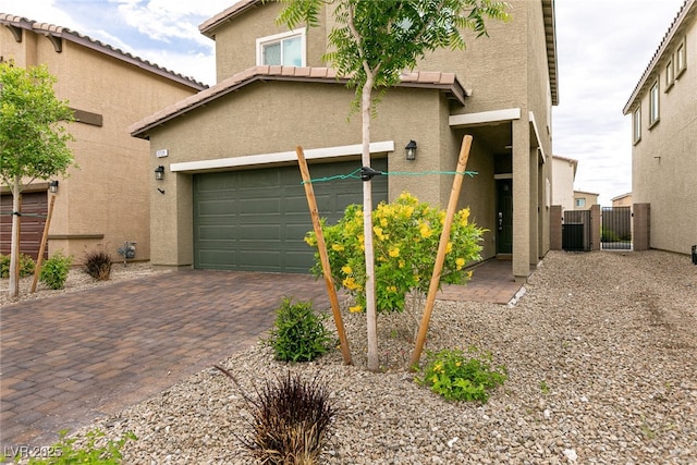 exterior space featuring fence, driveway, central AC unit, and a gate