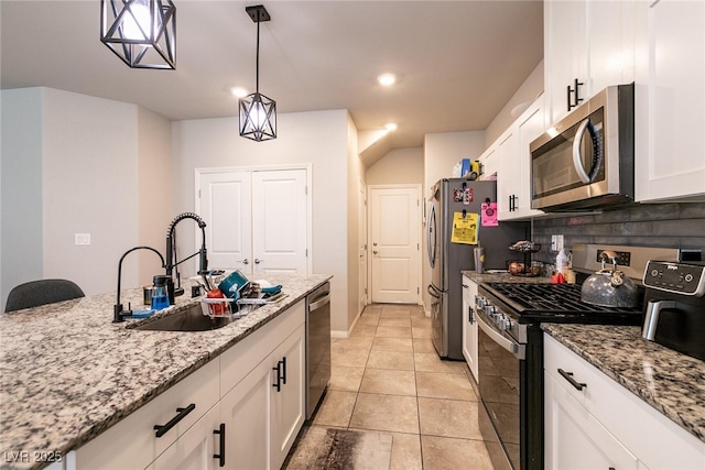 kitchen with white cabinets, stainless steel appliances, a sink, and tasteful backsplash