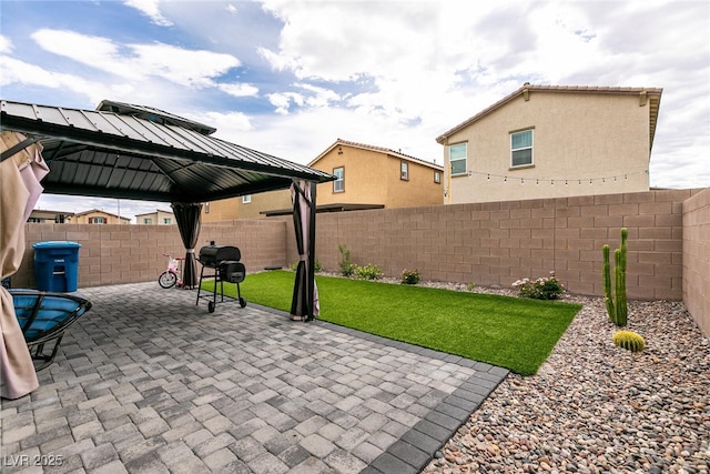 view of patio / terrace with a gazebo and a fenced backyard