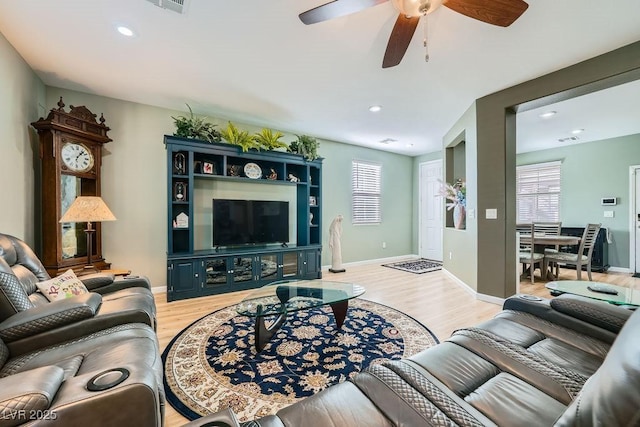 living room with light wood-type flooring, recessed lighting, baseboards, and ceiling fan