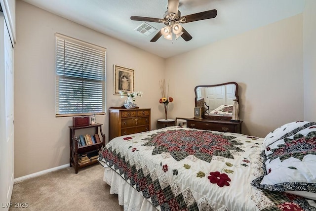 carpeted bedroom with baseboards, visible vents, and ceiling fan