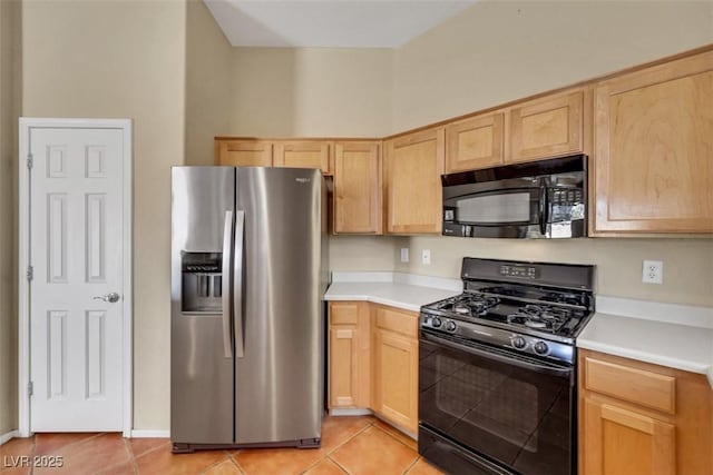 kitchen featuring light countertops, light tile patterned floors, black appliances, and light brown cabinets