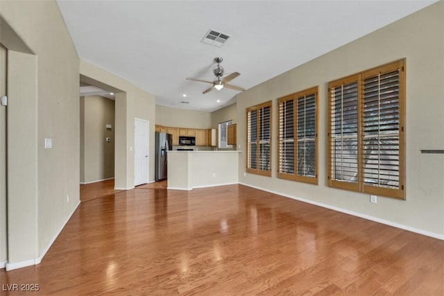 unfurnished living room with visible vents, wood finished floors, baseboards, ceiling fan, and recessed lighting
