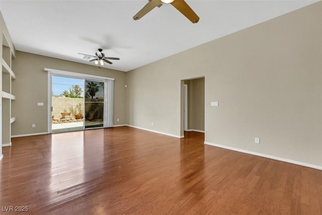 spare room with baseboards, a ceiling fan, and wood finished floors