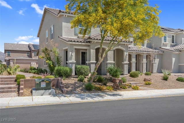 946 Belton Lake Ave, North Las Vegas, NV 89086 - mediterranean / spanish house featuring stucco siding, a tiled roof, and a residential view
