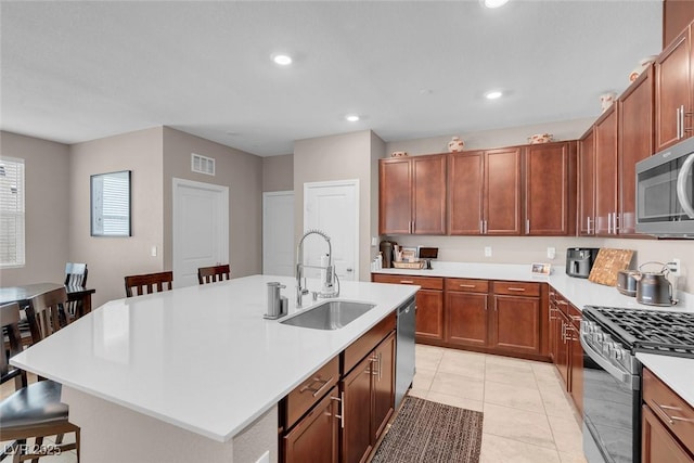 946 Belton Lake Ave, North Las Vegas, NV 89086 - kitchen featuring visible vents, a kitchen bar, light countertops, a sink, and stainless steel appliances