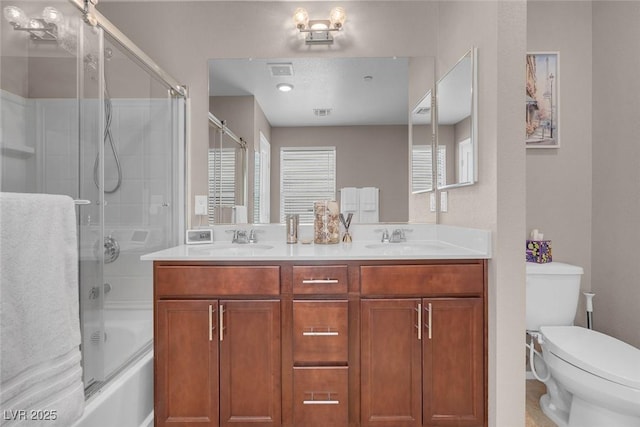 946 Belton Lake Ave, North Las Vegas, NV 89086 - bathroom featuring a sink, a wealth of natural light, shower / bath combination with glass door, and toilet