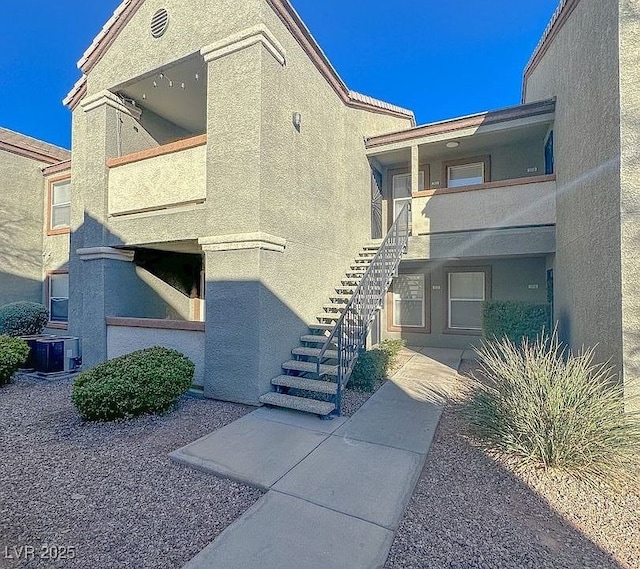 exterior space with central AC and stairs