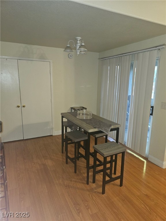 555 E Silverado Ranch Blvd Unit 2028, Las Vegas, NV 89183 - dining space featuring wood finished floors, a chandelier, and baseboards