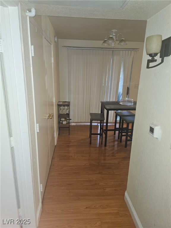 555 E Silverado Ranch Blvd Unit 2028, Las Vegas, NV 89183 - hall with wood finished floors, baseboards, and a textured wall