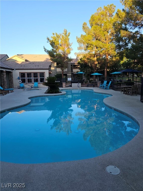 555 E Silverado Ranch Blvd Unit 2028, Las Vegas, NV 89183 - view of swimming pool featuring a patio area and fence