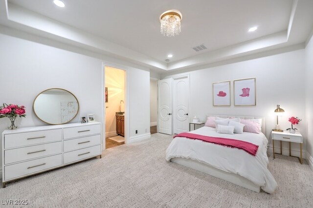 bedroom featuring light colored carpet, a tray ceiling, visible vents, and recessed lighting
