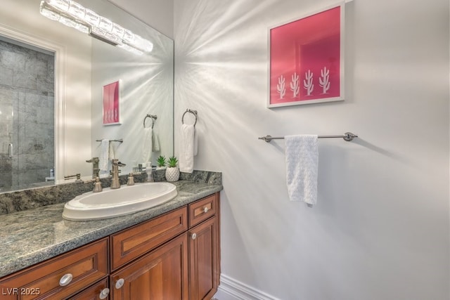 bathroom with vanity and a shower with door