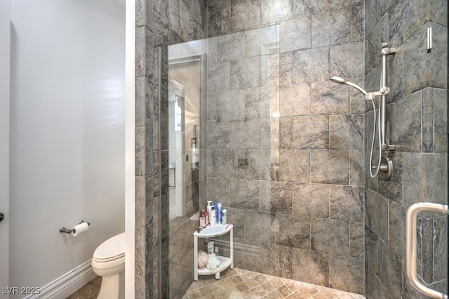 bathroom with a shower stall and toilet