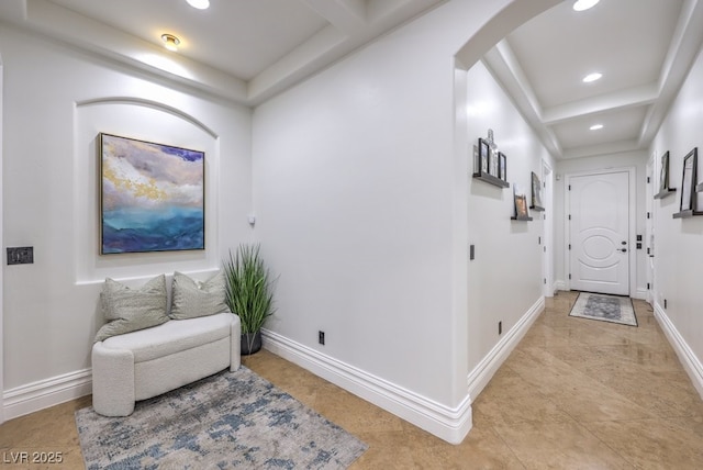 hall with arched walkways, baseboards, and recessed lighting