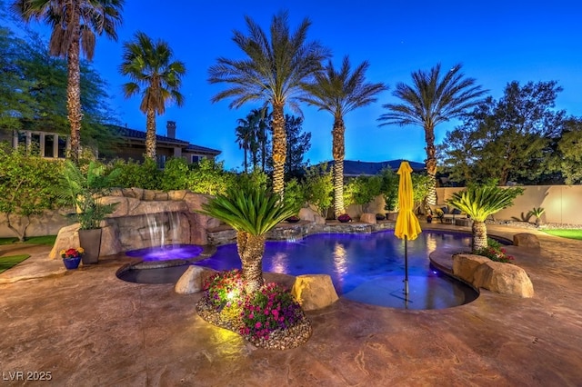 pool at twilight featuring a patio, a fenced in pool, and a fenced backyard