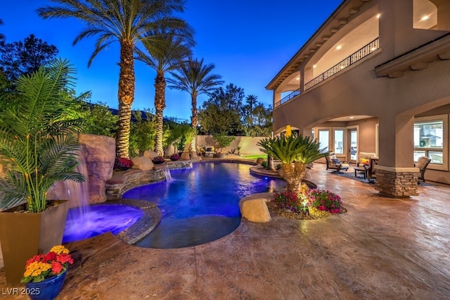 pool at twilight featuring a fenced in pool, a fenced backyard, a patio area, and french doors
