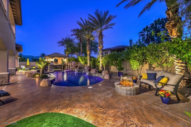 view of pool featuring a patio, a fenced in pool, a fenced backyard, and an outdoor fire pit