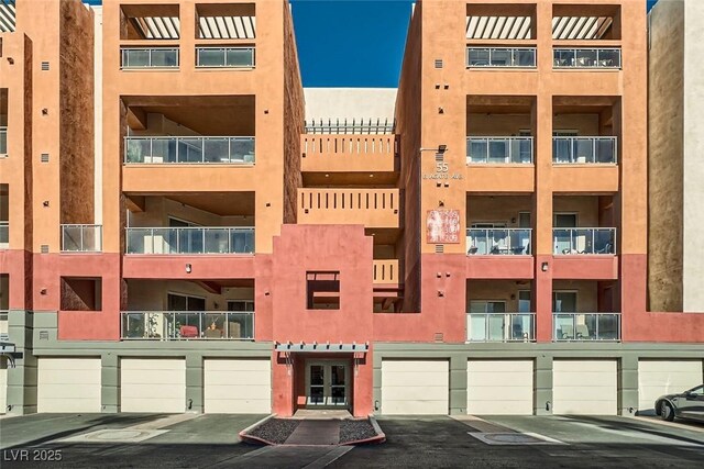 55 E Agate Ave Unit 202, Las Vegas, NV 89123 - view of building exterior featuring an attached garage and driveway