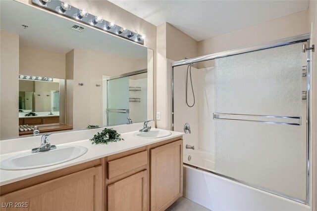 55 E Agate Ave Unit 202, Las Vegas, NV 89123 - bathroom featuring double vanity, a sink, enclosed tub / shower combo, and visible vents