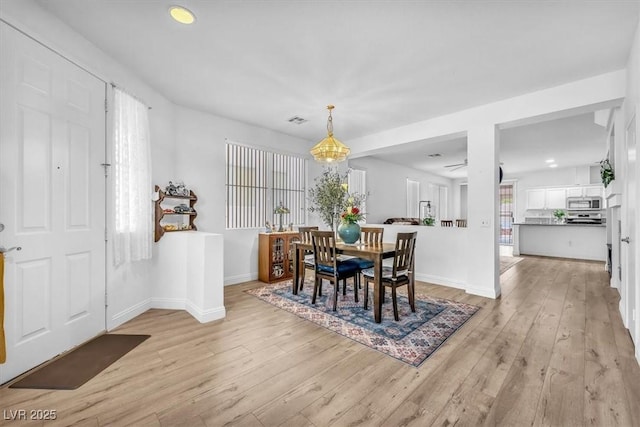 dining room featuring light wood-type flooring, recessed lighting, baseboards, and visible vents