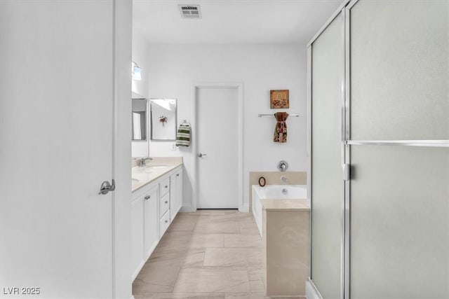 full bath with visible vents, a shower stall, a garden tub, and vanity
